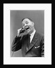 1930s man in suit laughing talking on telephone by Anonymous