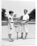 1920s 1930s two boys tennis match holding rackets measuring net height by Anonymous
