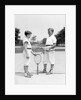 1920s 1930s two boys tennis match holding rackets measuring net height by Anonymous