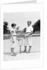 1920s 1930s two boys tennis match holding rackets measuring net height by Anonymous