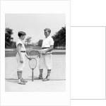 1920s 1930s two boys tennis match holding rackets measuring net height by Anonymous
