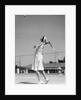 1930s woman playing tennis about to hit ball with racket by Anonymous