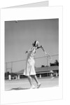 1930s woman playing tennis about to hit ball with racket by Anonymous