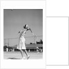 1930s woman playing tennis about to hit ball with racket by Anonymous