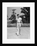 1930s man walking across tennis court holding tennis racket & balls by Anonymous