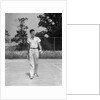 1930s man walking across tennis court holding tennis racket & balls by Anonymous