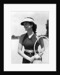 1930s woman in polka dot halter top shorts & sun visor holding a tennis ball & racket by Anonymous