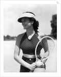 1930s woman in polka dot halter top shorts & sun visor holding a tennis ball & racket by Anonymous