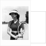 1930s woman in polka dot halter top shorts & sun visor holding a tennis ball & racket by Anonymous