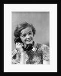 1930s teen girl smiling brunette print dress talking on telephone by Anonymous