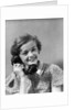 1930s teen girl smiling brunette print dress talking on telephone by Anonymous