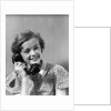 1930s teen girl smiling brunette print dress talking on telephone by Anonymous