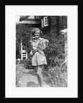 1930s teen girl brunette on sidewalk of house holding tennis racket wearing shorts by Anonymous