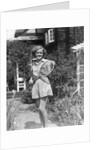1930s teen girl brunette on sidewalk of house holding tennis racket wearing shorts by Anonymous