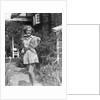 1930s teen girl brunette on sidewalk of house holding tennis racket wearing shorts by Anonymous