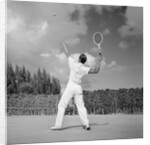 1930s back view of man playing tennis about to hit the ball summer outdoor by Anonymous