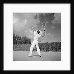 1930s back view of man playing tennis about to hit the ball summer outdoor by Anonymous