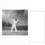1930s back view of man playing tennis about to hit the ball summer outdoor by Anonymous