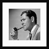 1950s frowning businessman in jacket and tie smoking a pipe by Anonymous