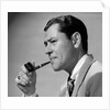 1950s frowning businessman in jacket and tie smoking a pipe by Anonymous