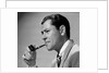 1950s frowning businessman in jacket and tie smoking a pipe by Anonymous