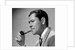 1950s frowning businessman in jacket and tie smoking a pipe by Anonymous