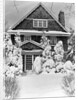 1940s three story shingle style house with pine trees and shrubs covered with snow by Anonymous