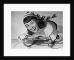 1950s smiling young teenage woman posing on sled in winter wool knit clothes looking at camera by Anonymous