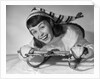 1950s smiling young teenage woman posing on sled in winter wool knit clothes looking at camera by Anonymous