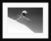 1950s man skier skiing down slope jumping into air by Anonymous