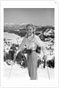 1940s 1950s young blond athletic woman looking at camera smiling standing with ski poles top of mountain by Anonymous
