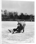 1920s 1930s two smiling boys looking at camera ice skating one boy fallen other picking him up by Anonymous