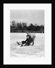 1920s 1930s two smiling boys looking at camera ice skating one boy fallen other picking him up by Anonymous
