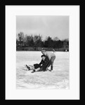 1920s 1930s two smiling boys looking at camera ice skating one boy fallen other picking him up by Anonymous
