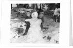 1950s 1960s smiling boy and girl building a snowman together in snowy woods by Anonymous