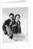 1920s 1930s smiling couple man and woman on toboggan in winter by Anonymous