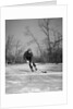 1940s man playing ice hockey on frozen lake controlling puck with stick by Anonymous