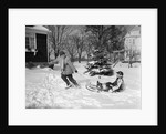 1950s woman mother pulling boy son on sled in winter by Anonymous