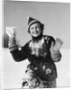 1930s smiling young woman covered in snow throwing piece of snow squinting looking at camera by Anonymous