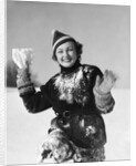 1930s smiling young woman covered in snow throwing piece of snow squinting looking at camera by Anonymous