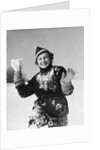 1930s smiling young woman covered in snow throwing piece of snow squinting looking at camera by Anonymous