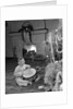 1950s little boy playing toy drum by christmas tree and fireplace looking at camera by Anonymous