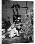 1950s smiling little girl christmas tree talking on toy telephone by Anonymous