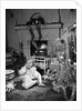 1950s smiling little girl christmas tree talking on toy telephone by Anonymous