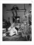 1950s smiling little girl christmas tree talking on toy telephone by Anonymous