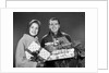 1960s smiling couple man and woman holding wrapped christmas presents and packages by Anonymous