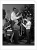 1960s family father mother two sons trimming christmas tree with string of popcorn by Anonymous