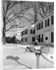 1960s woman walking to rural mailbox in front of home in snow piled with christmas packages by Anonymous