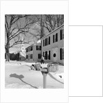1960s woman walking to rural mailbox in front of home in snow piled with christmas packages by Anonymous