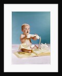 1960s baby surprised facial expression holding telephone hand set over yellow pages phone book directory by Anonymous